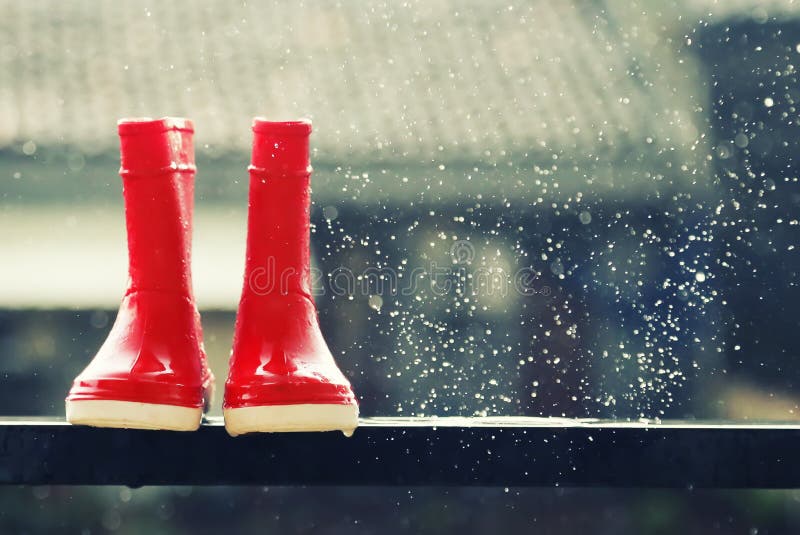 Photo of red boots under rain. Photo of red boots under rain