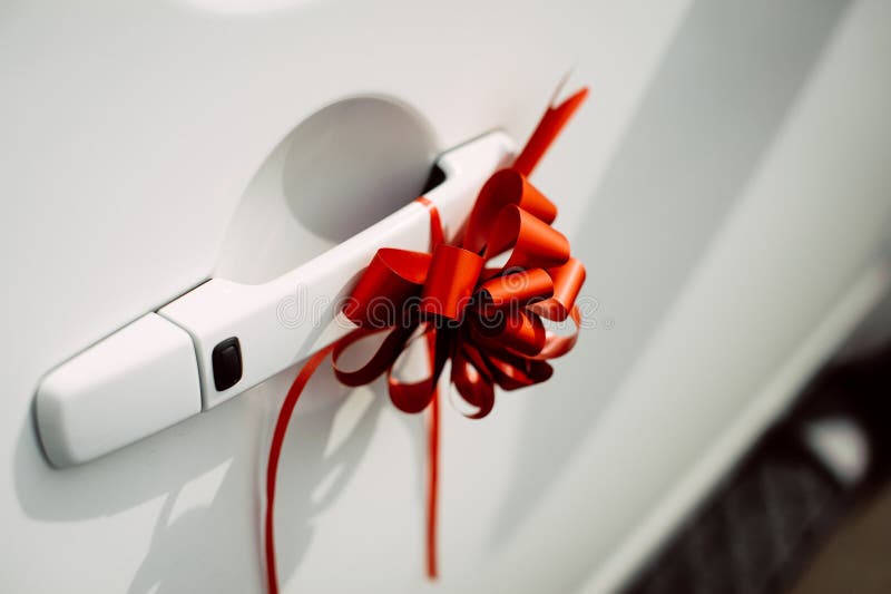Red Ribbon Bow on the Door Handle of a White Car Stock Image Image of