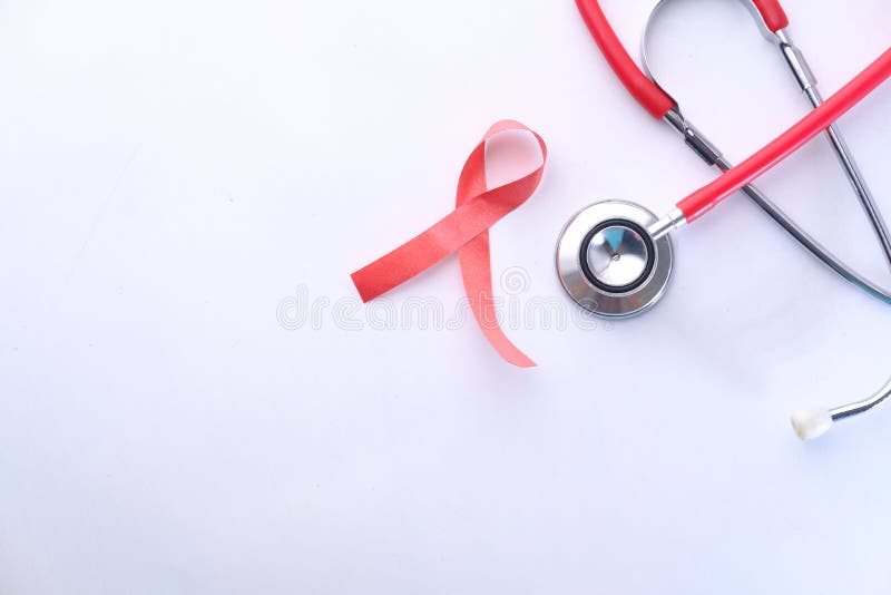 Red ribbon HIV, and stethoscope on white background. royalty free stock photos