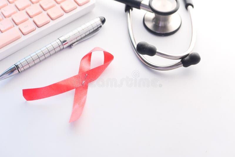 Red ribbon HIV, and stethoscope on white background. royalty free stock photography