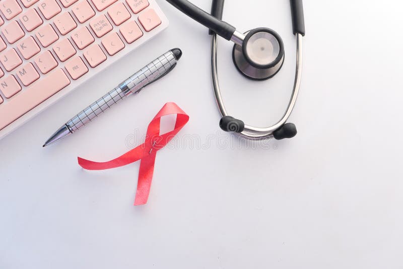 Red ribbon HIV, and stethoscope on white background. royalty free stock images