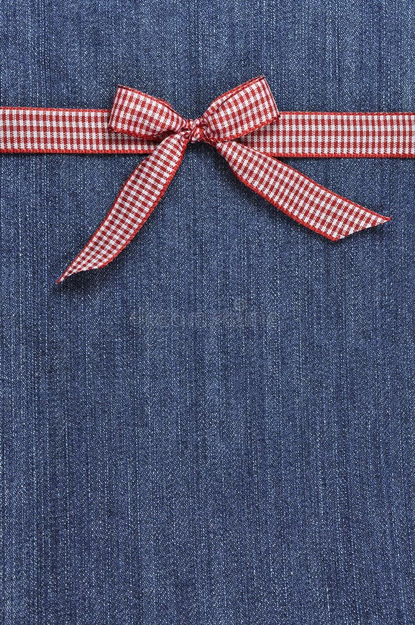 Red ribbon on a jeans background