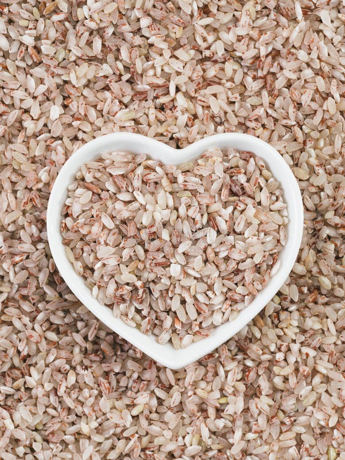 Red Rice In Heartshaped Bowl On Rice Background Stock Photo Image of ingredient, agricultural