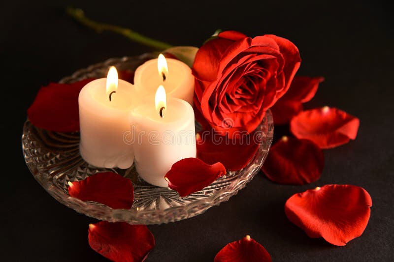Red Rose, Candles, Red Rose Petals on Black Background Stock Photo