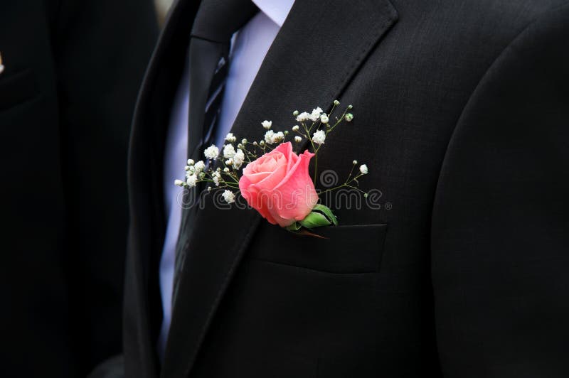 Red rose on a groom coat