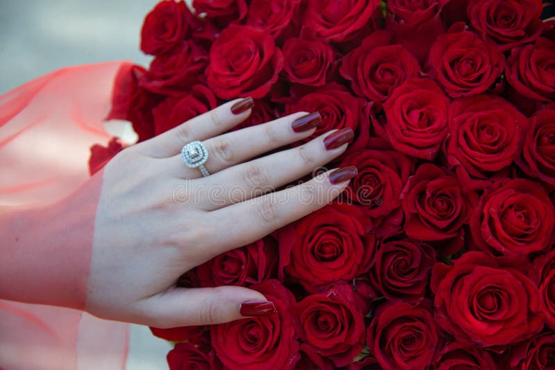 Red Roses Bouquet with Engagement Ring. Bride with Flower Bouquet and