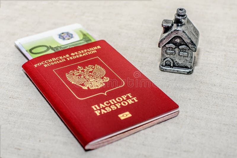 Red russian Passport, money and home - the concept of buying a property. royalty free stock photography Red russian Passport, money and home - the concept of buying a property. royalty free stock photography