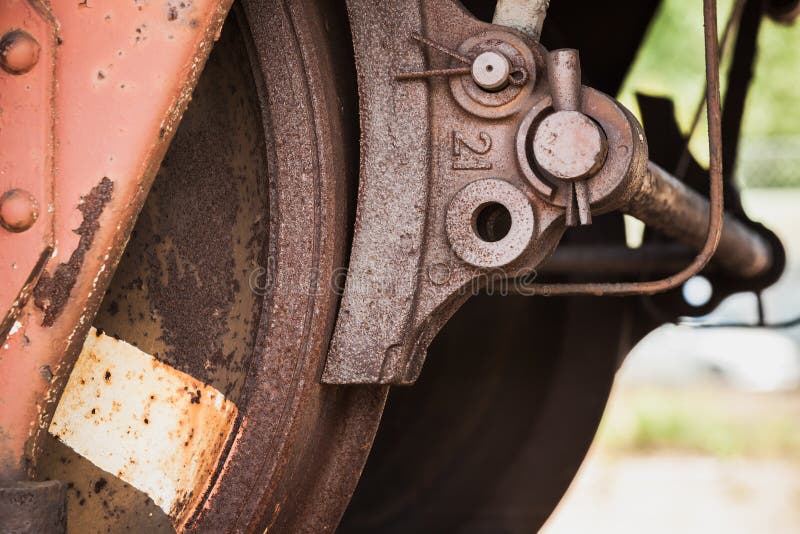 Red rusted wheel with brake of railway carriage