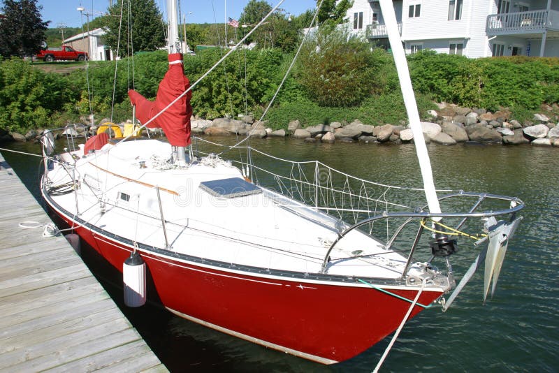 red hull sailboat