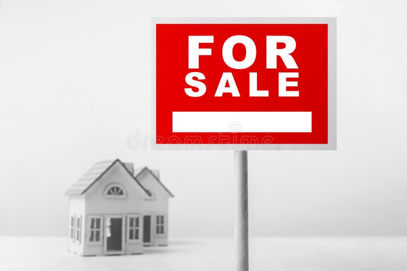 Red For Sale Real Estate Sign in Front of Small House Model. stock images Red For Sale Real Estate Sign in Front of Small House Model. stock images