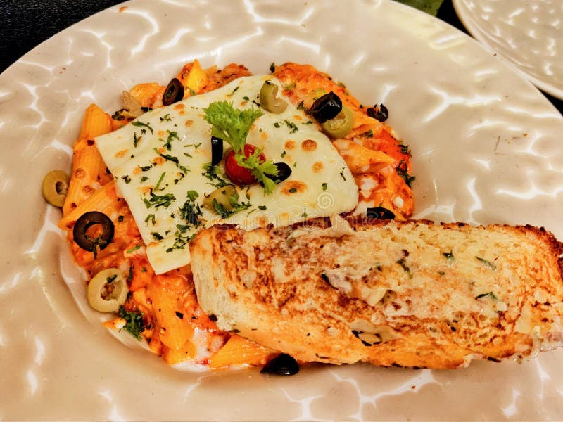 Red Sauce Pasta with Extra Cheese and Garlic Bread Stock Image - Image