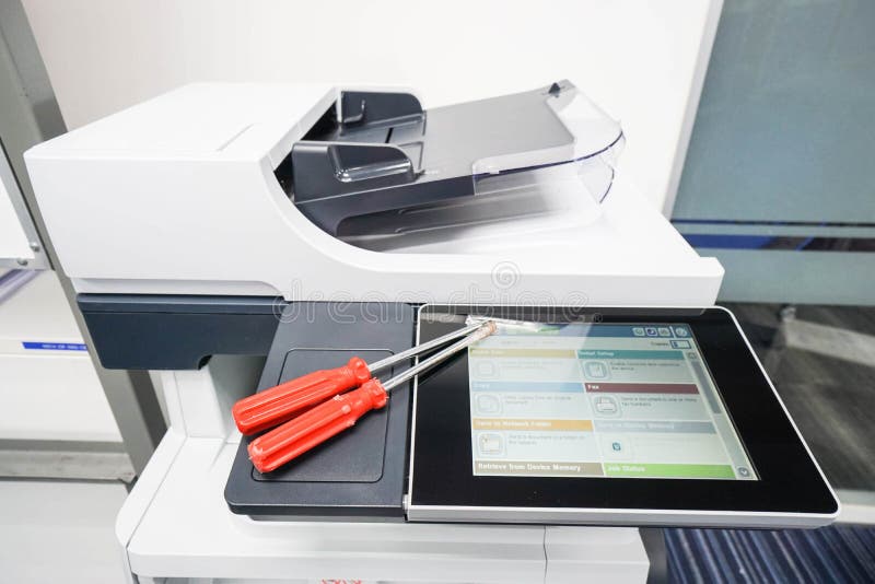 Two Red Screwdrivers on Printer To Repair Assistance Stock Photo