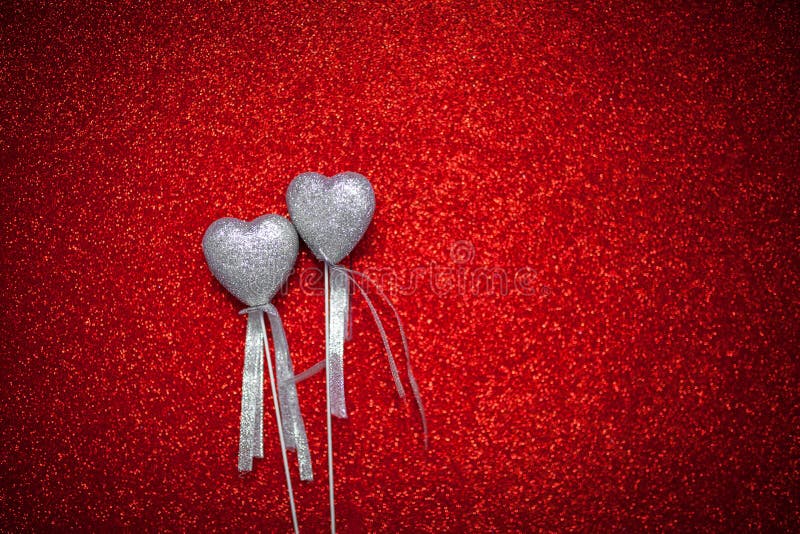 Red shiny background with silver hearts, love, Valentine`s Day, texture abstract background, romantic picture, suitable for adver