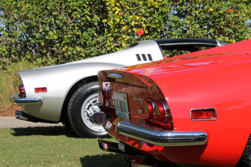 Classic red Ferrari Dino 246 GT berlinetta sports car in line up next to silver Dino 246 GT spider sports car at Cavallino 2012. rear corner. Classic red Ferrari Dino 246 GT berlinetta sports car in line up next to silver Dino 246 GT spider sports car at Cavallino 2012. rear corner.