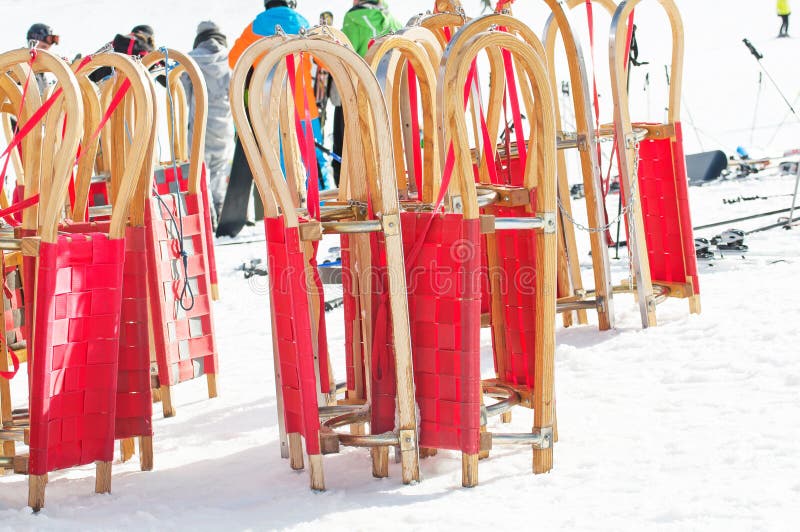 Red sledges and ski people