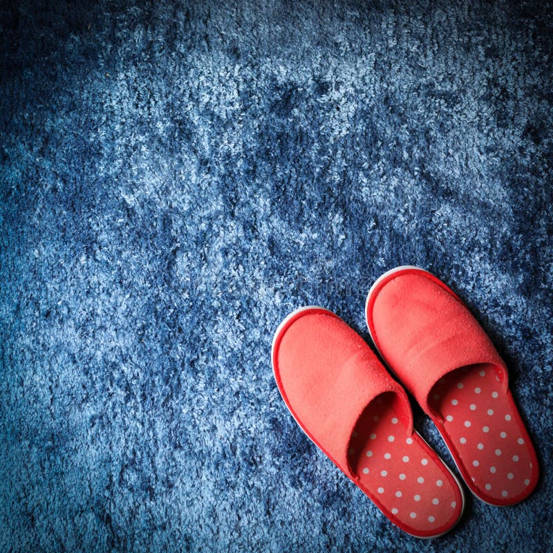 Red slipper shoe on blue carpet floor softness mat