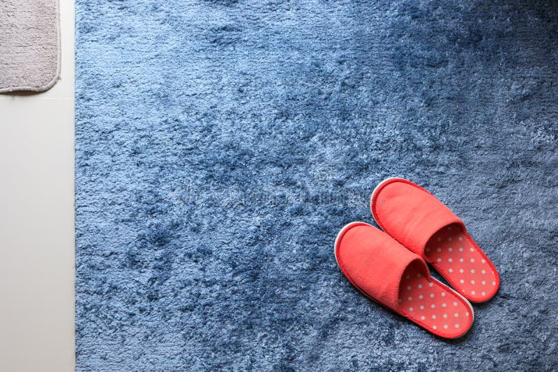 Red slipper shoe on blue carpet floor softness mat