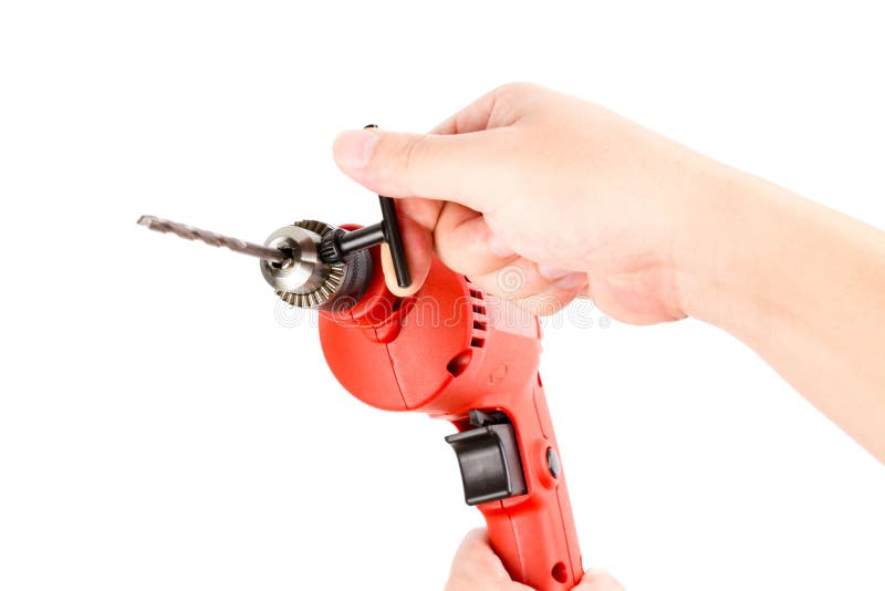 Red Small Electric drill machine with drill bit and hand. royalty free stock photo Red Small Electric drill machine with drill bit and hand. royalty free stock photo