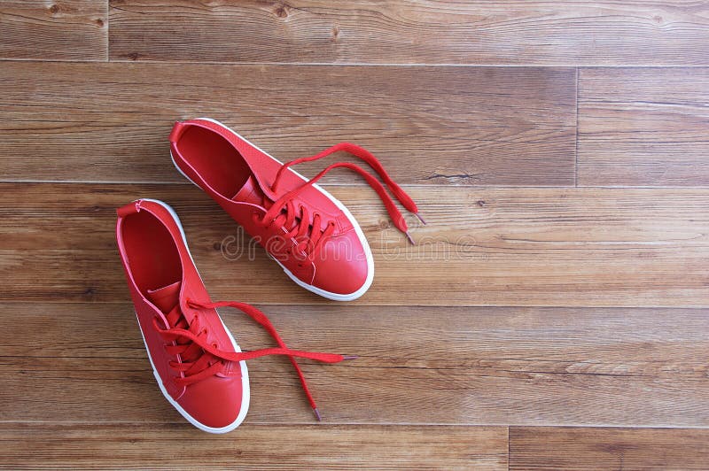 Red Sneakers Stand on Brown Wooden Floor. View from Above Stock Image ...