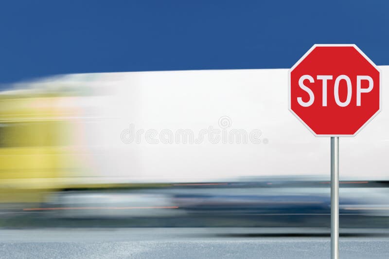 Red stop road sign motion blurred truck vehicle traffic background, regulatory warning signage octagon, white octagonal frame