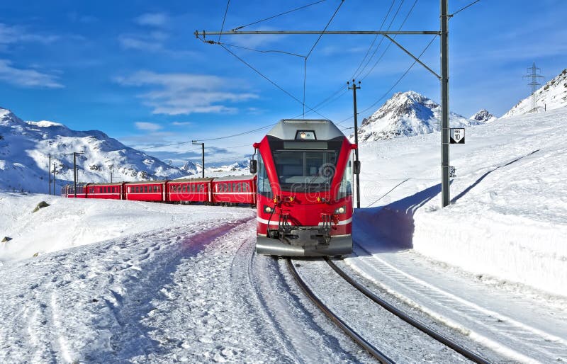 A Red Swiss Train Running through the Snow Stock Photo Image of