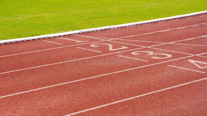 Red Synthetic Running Tracks With Numbers And Green Field In Athletic red-synthetic-running-tracks-with-numbers-and-green-field-in-athletic