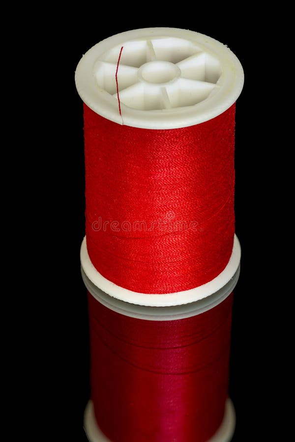 Red thread on a plastic spool for sewing royalty free stock image Red thread on a plastic spool for sewing royalty free stock image