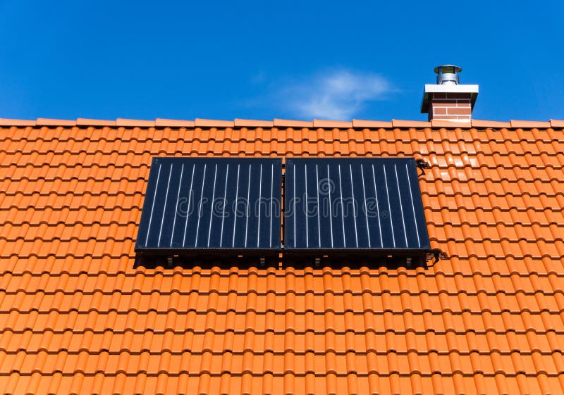 Red tiled roof with solar thermal plant and chimney royalty free stock photography Red tiled roof with solar thermal plant and chimney royalty free stock photography