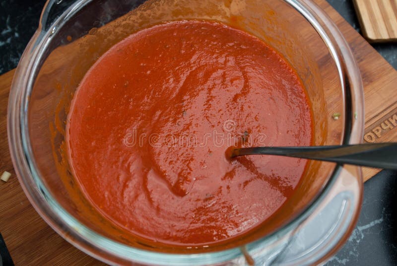 Red Tomatoe or chilly Sauce in Glass Bowl with spoon. Food Preparing Process. Food Ingredients. Restaurant Kitchen.