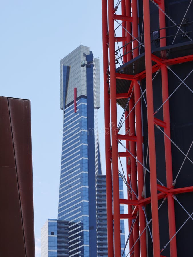 A red tower and a blue skyscraper