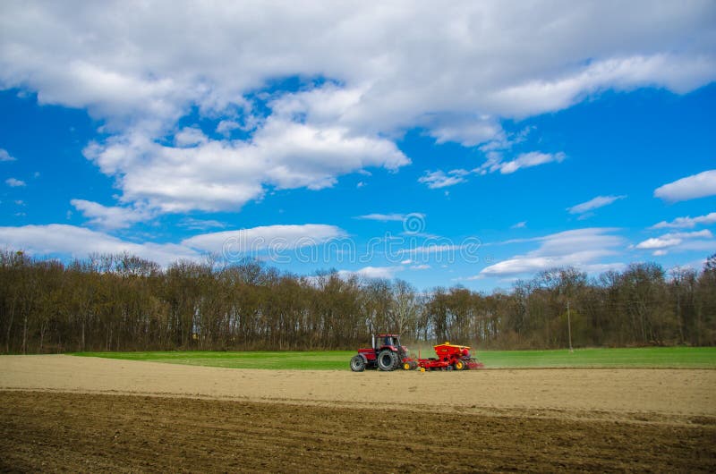 Red tractor on a field stock photo. Image of preparation 30517296