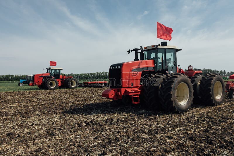 Red Tractor with Large Wheels in the Field during Tests during the