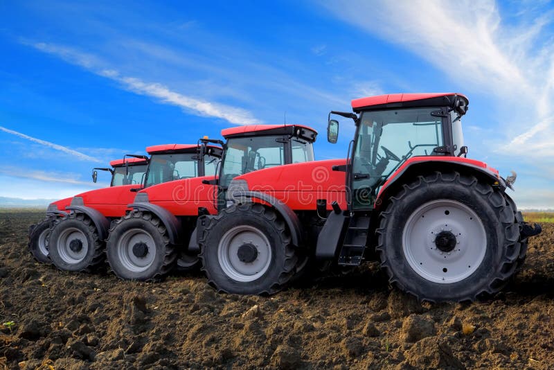 Red tractors on field stock photo. Image of stationary 11814112