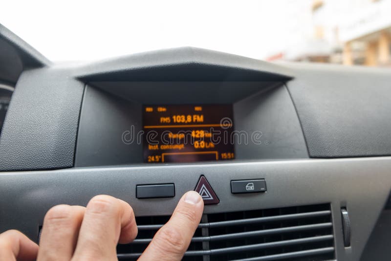 Red triangle emergency button in a car interior stock photography