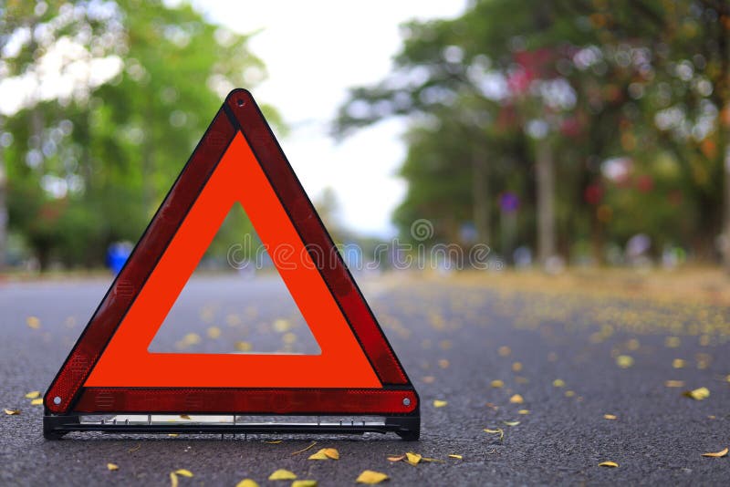 Red triangle, red emergency stop sign, red emergency symbol on road. With copy space for text or design royalty free stock image