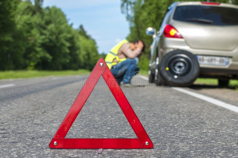 Red triangle sign and Sad man after car breakdown royalty free stock images Red triangle sign and Sad man after car breakdown royalty free stock images