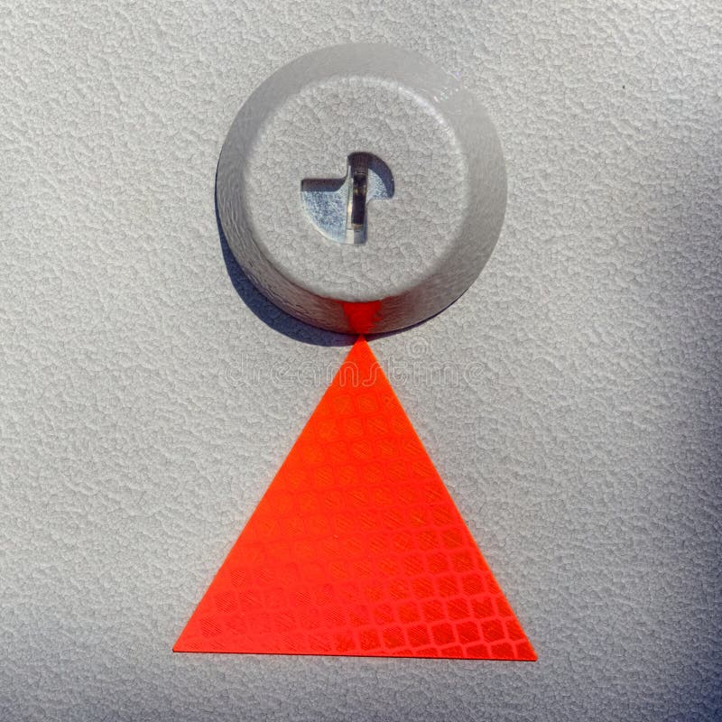 Red triangle on textured metal stock image Red triangle on textured metal stock image