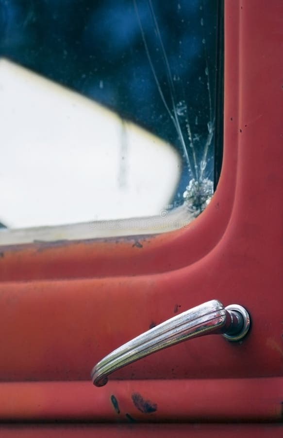 Red Truck Doorhandle and Broken Window Focus on Doorhandle