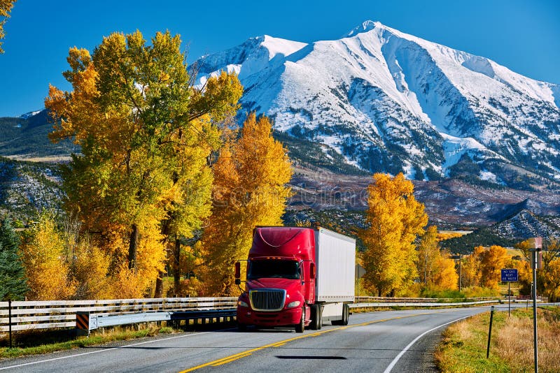 Red truck on highway in Colorado at autumn