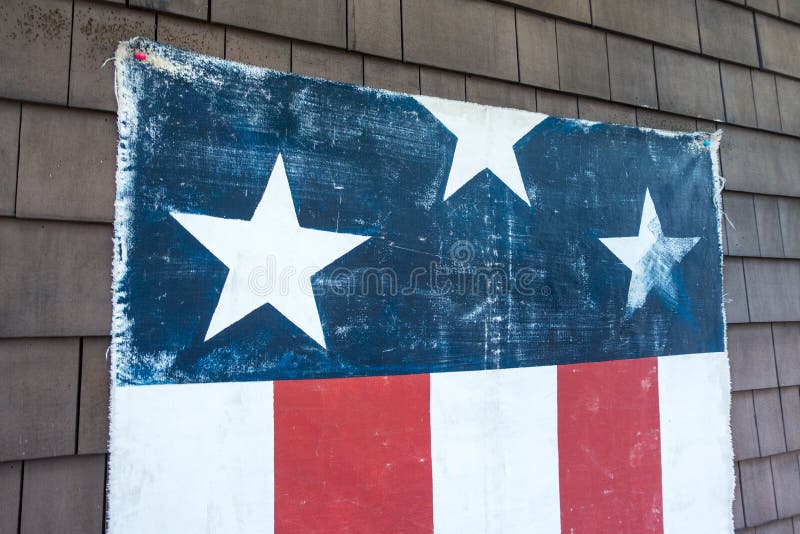 Red white blue flag with three stars pined to an outsited wood wall american holiday july fourth royalty free stock image Red white blue flag with three stars pined to an outsited wood wall american holiday july fourth royalty free stock image