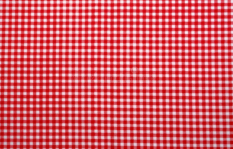 Red and white checkered tablecloth. Top view table cloth texture background. Red gingham pattern fabric. Picnic blanket texture.