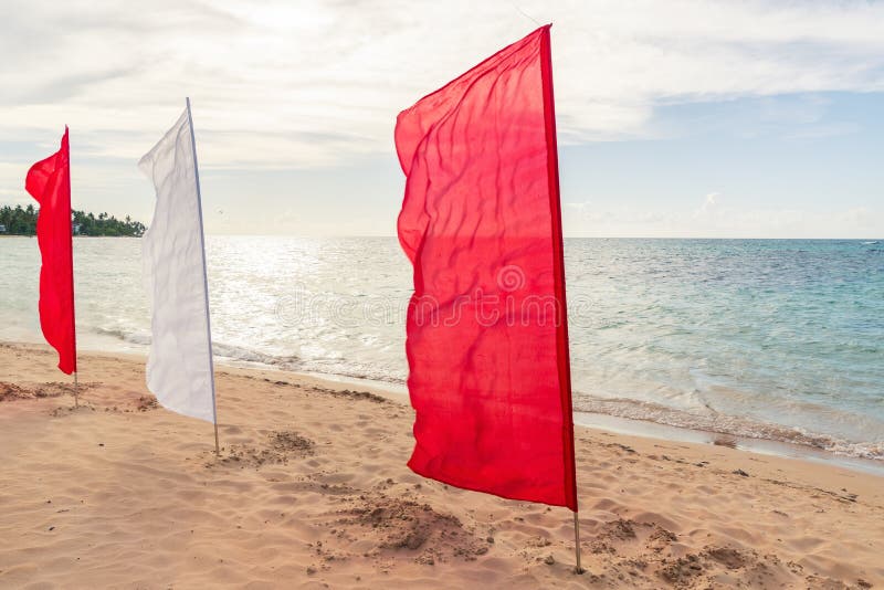 Red And White Flags On The Beach At Sunset Stock Photo Image of