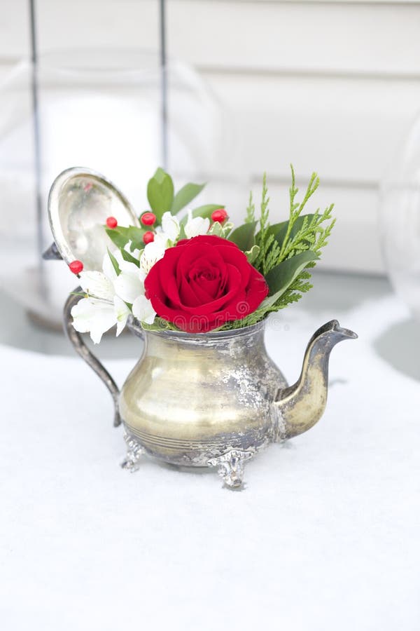 Red and White floral arrangement in antique teapot