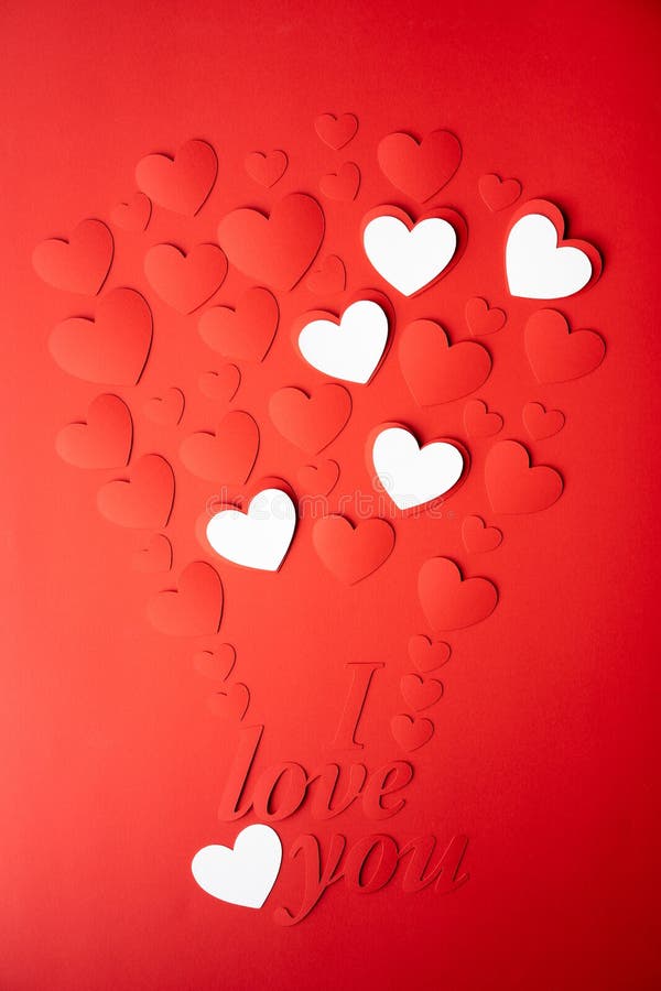 Red and white paper background, cut out hearts are lined up in the shape of a balloon. Words I love you. Set of 4 photos. royalty free stock photography Red and white paper background, cut out hearts are lined up in the shape of a balloon. Words I love you. Set of 4 photos. royalty free stock photography