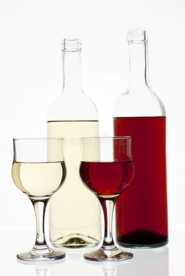 Glasses of Red and White Wine, with Red and White Wine Bottles Behind