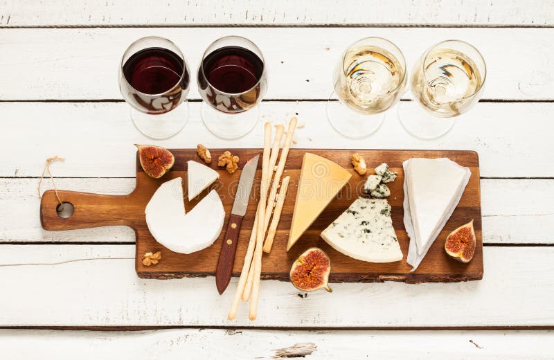 Red and white wine plus different kinds of cheeses (cheeseboard)