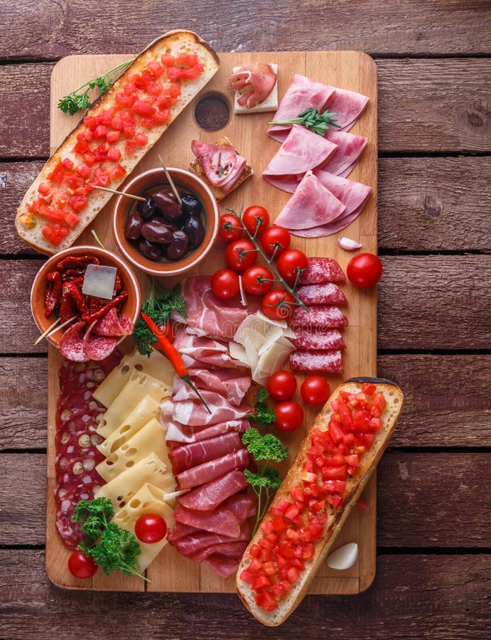 Red Wine with Charcuterie Assortment on Dark Rustic Table, Flat Lay