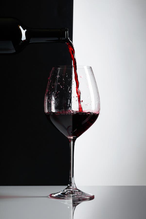 Red wine is poured into a glass.