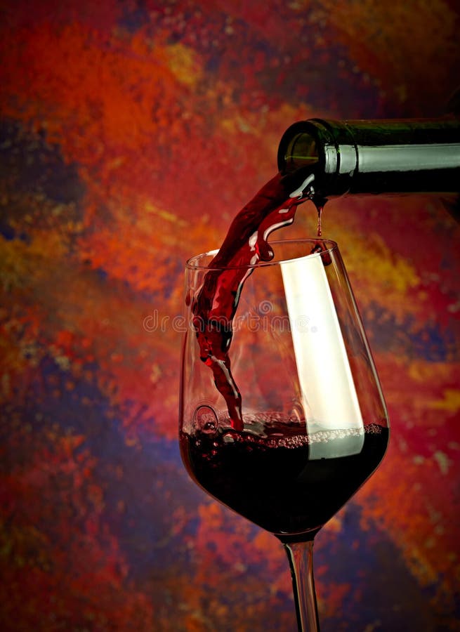 Red wine pouring in glass