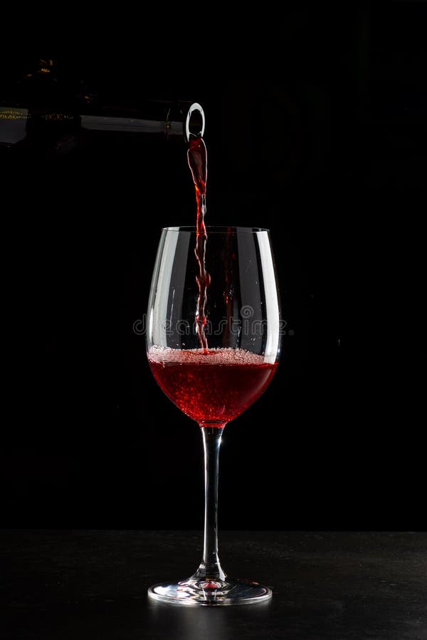 Red Wine Pouring into a Glass with Drops on Black Background Stock Image -  Image of background, party: 179752531
